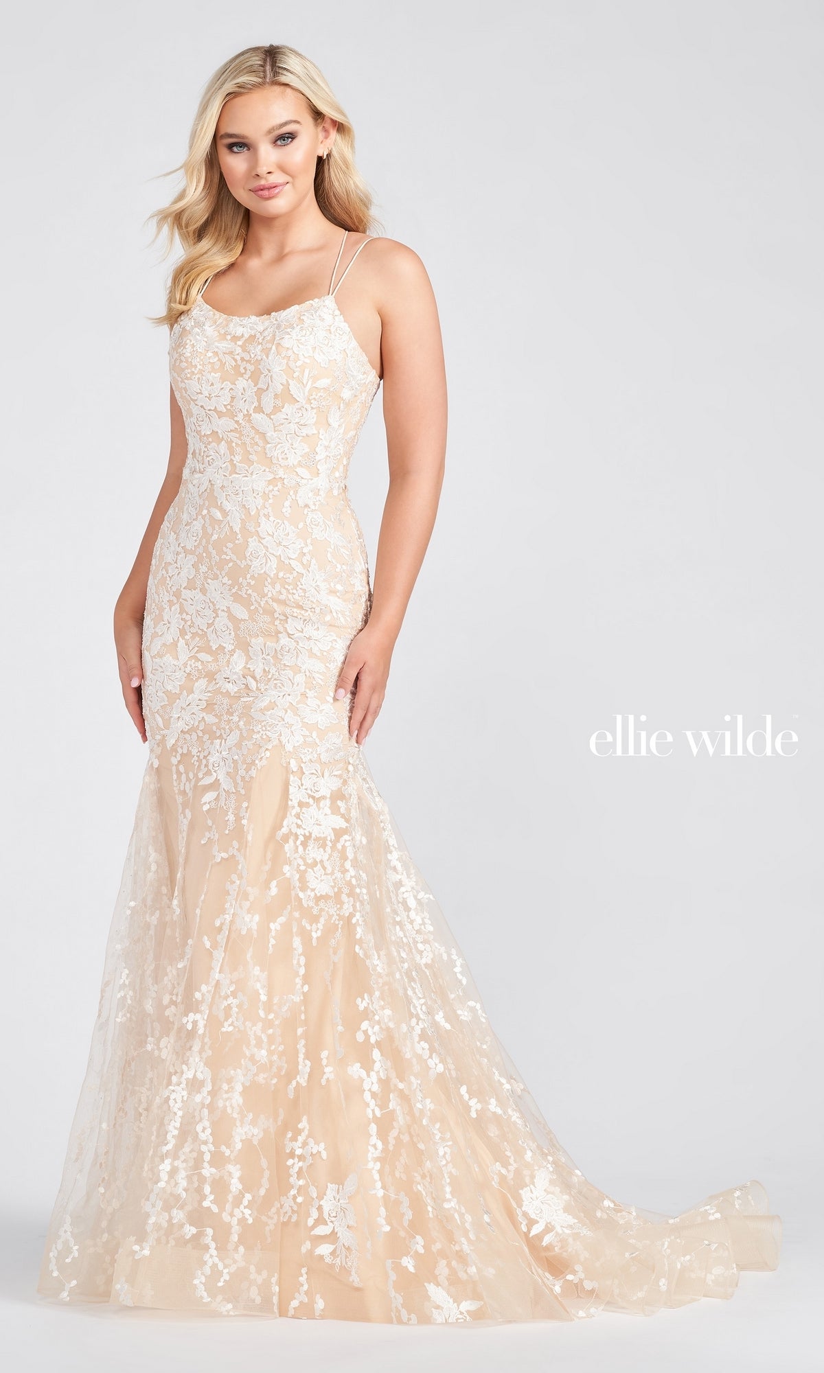 A woman models the Long Lace Mermaid Prom Dress with Strappy Back, featuring white floral details, against a plain background. The